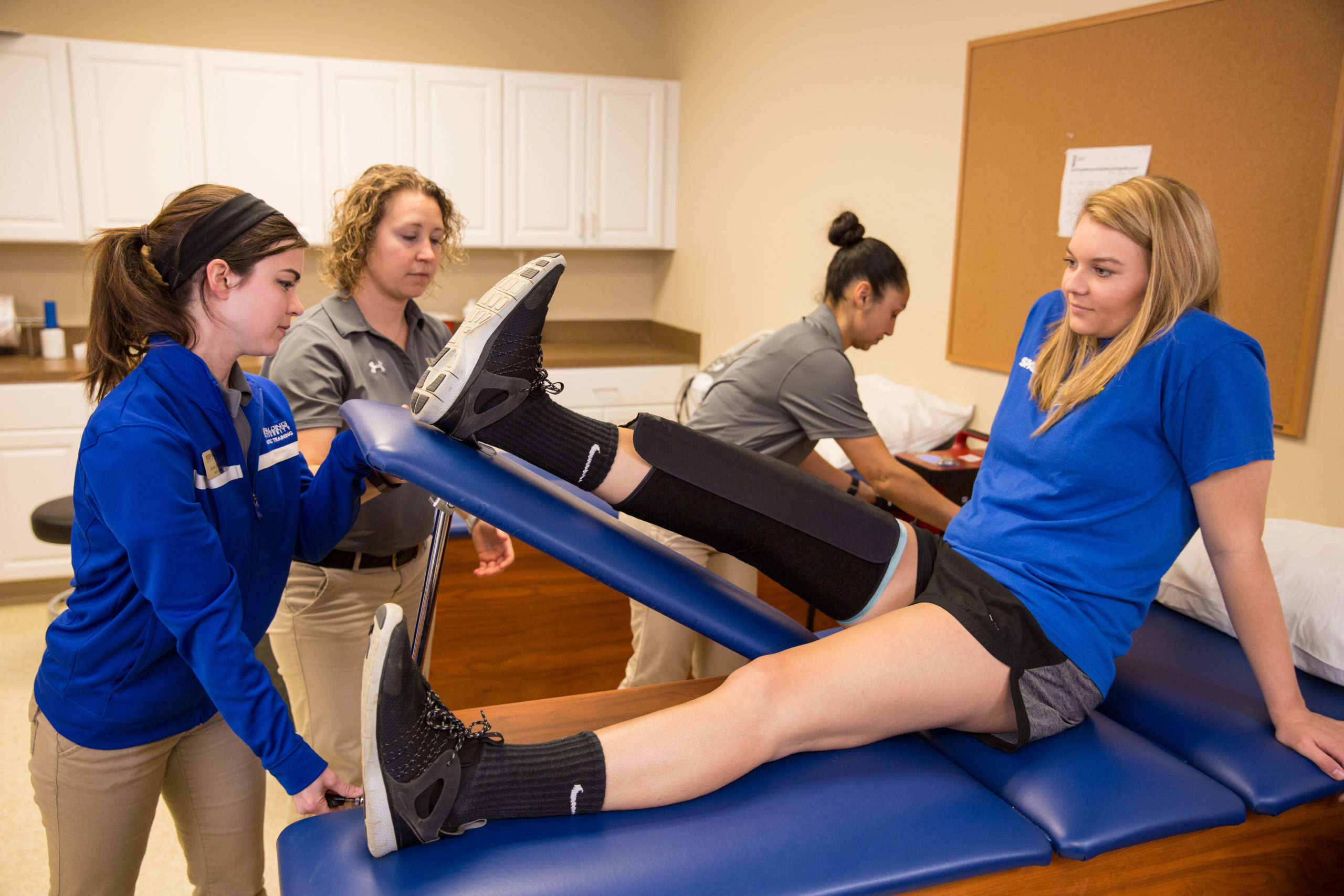 Spalding athletic training students working with Spalding athlete