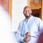 male professor smiling at class
