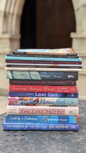 Stack of books written by Spalding School of Writing faculty members.