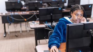female student on desktop computer
