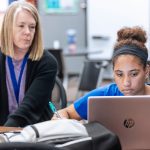 teacher and student with laptop
