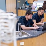 male students in science lab