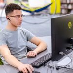 male student sitting at computer