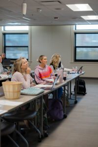 3 students at a desk
