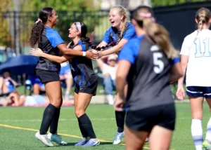 women celebrating at soccer game
